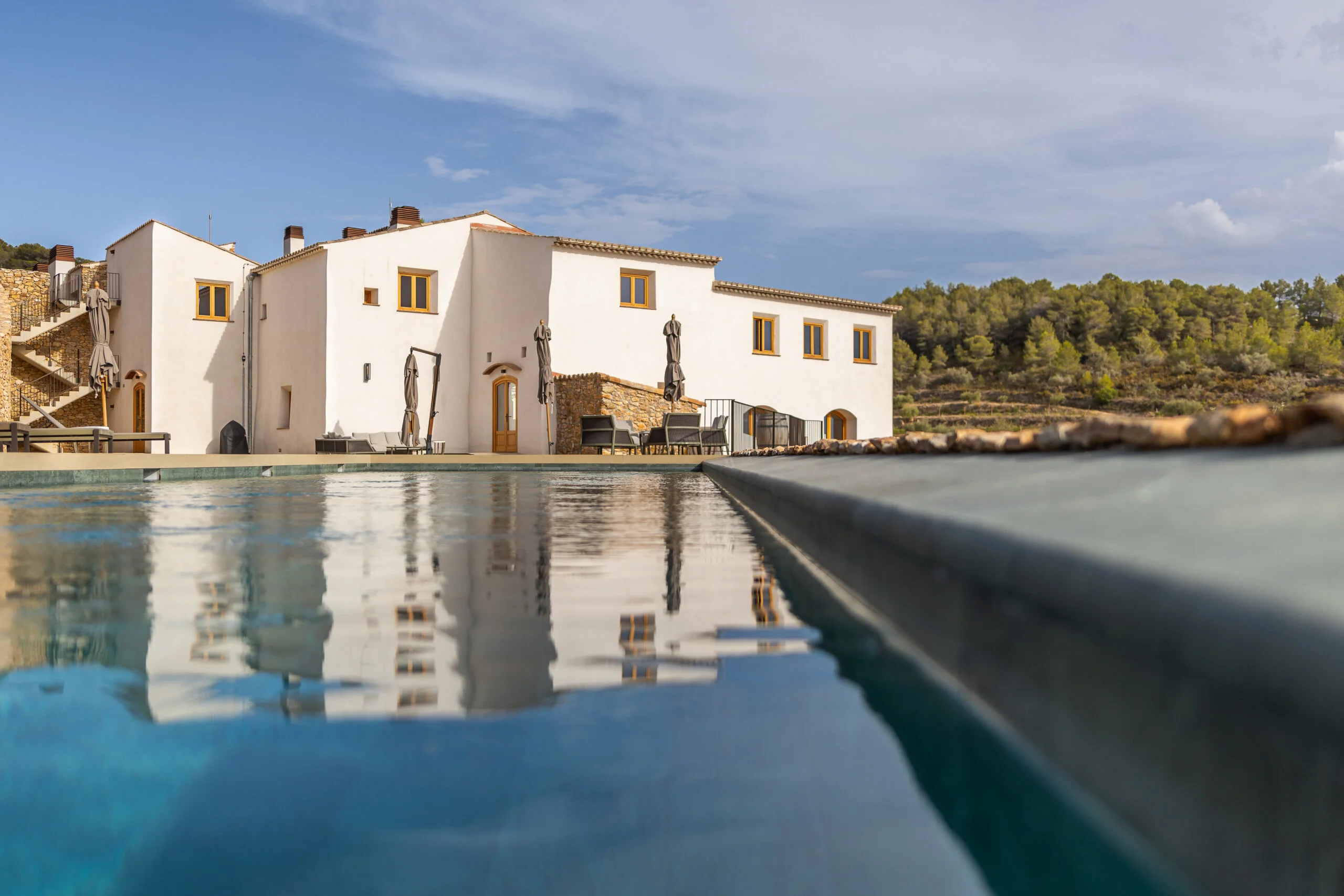 Infinity pool at Masia Cabellut with views of the vineyard.